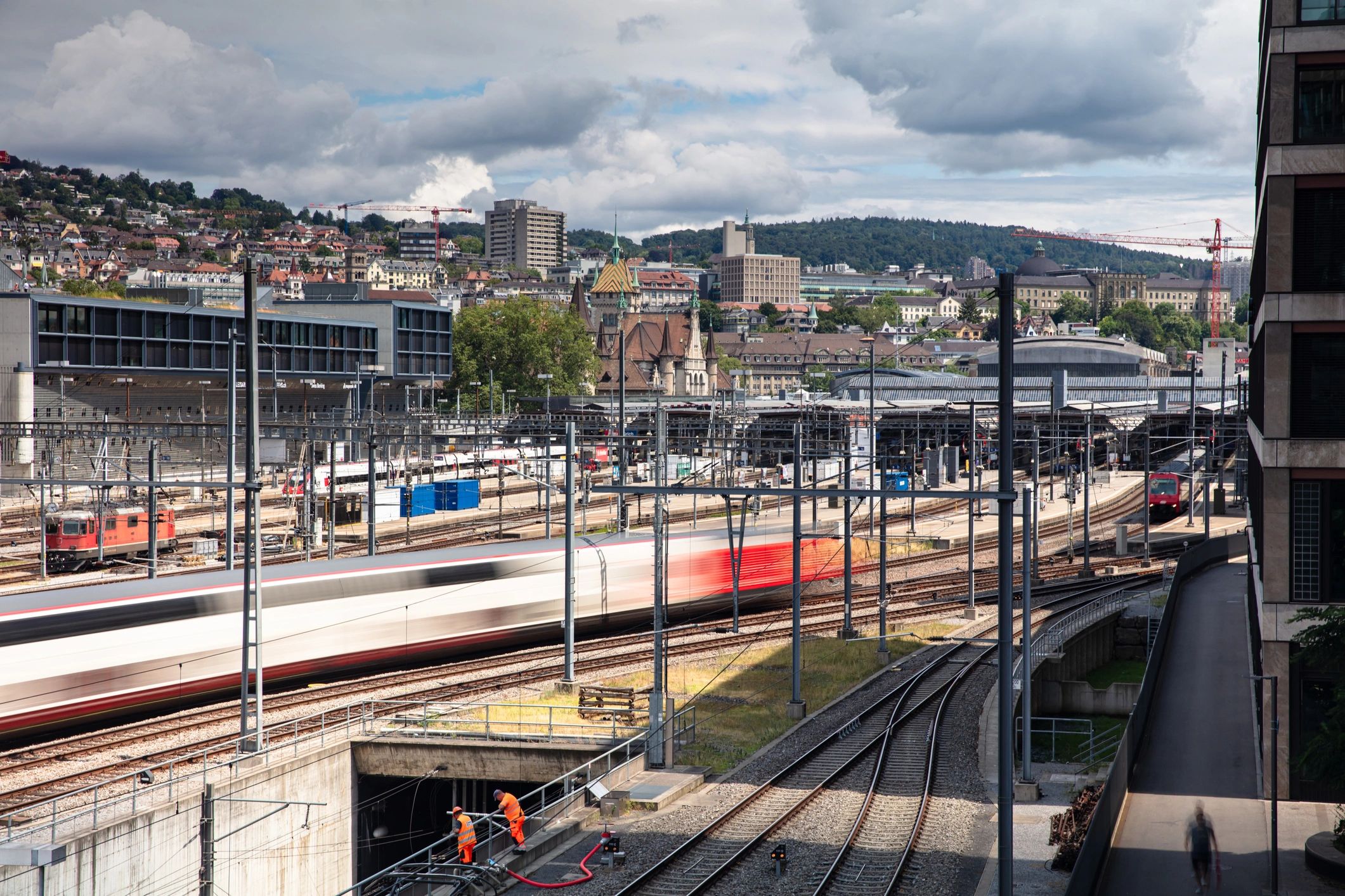 Train passing a platform in Zurich in bright morning light