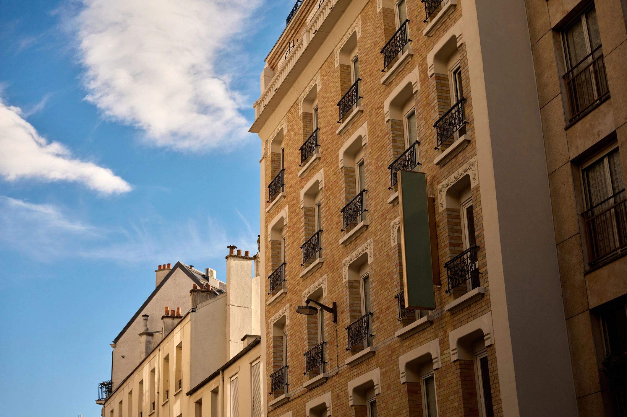 Haussmann-style building facade in Paris under blue sky