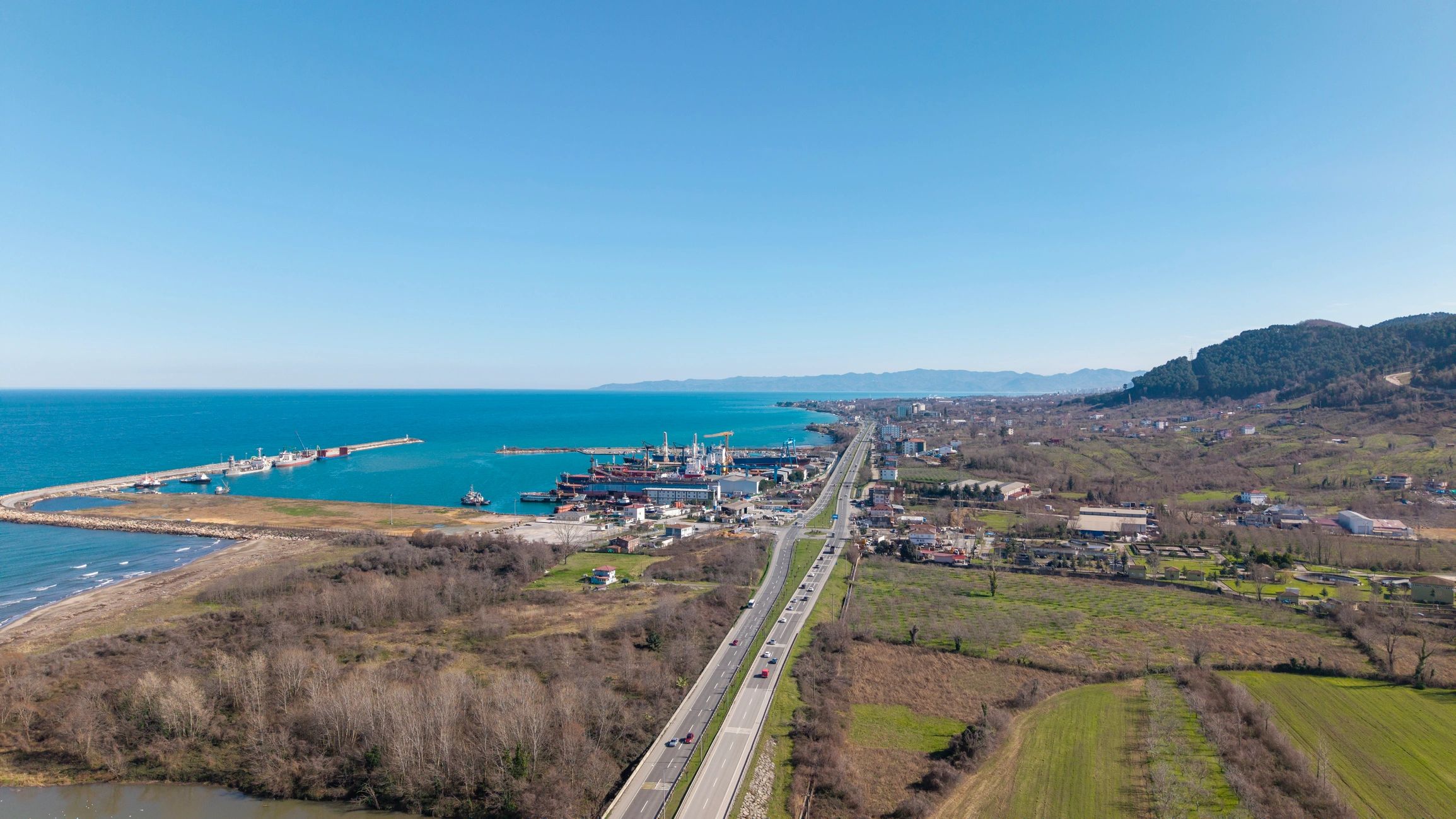 Aerial view of a coastal harbor and highway
